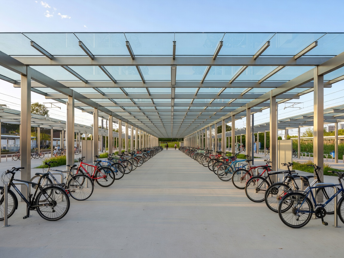 Transit interchange bicycle parking pavilion with clear glass roof and wide aisles